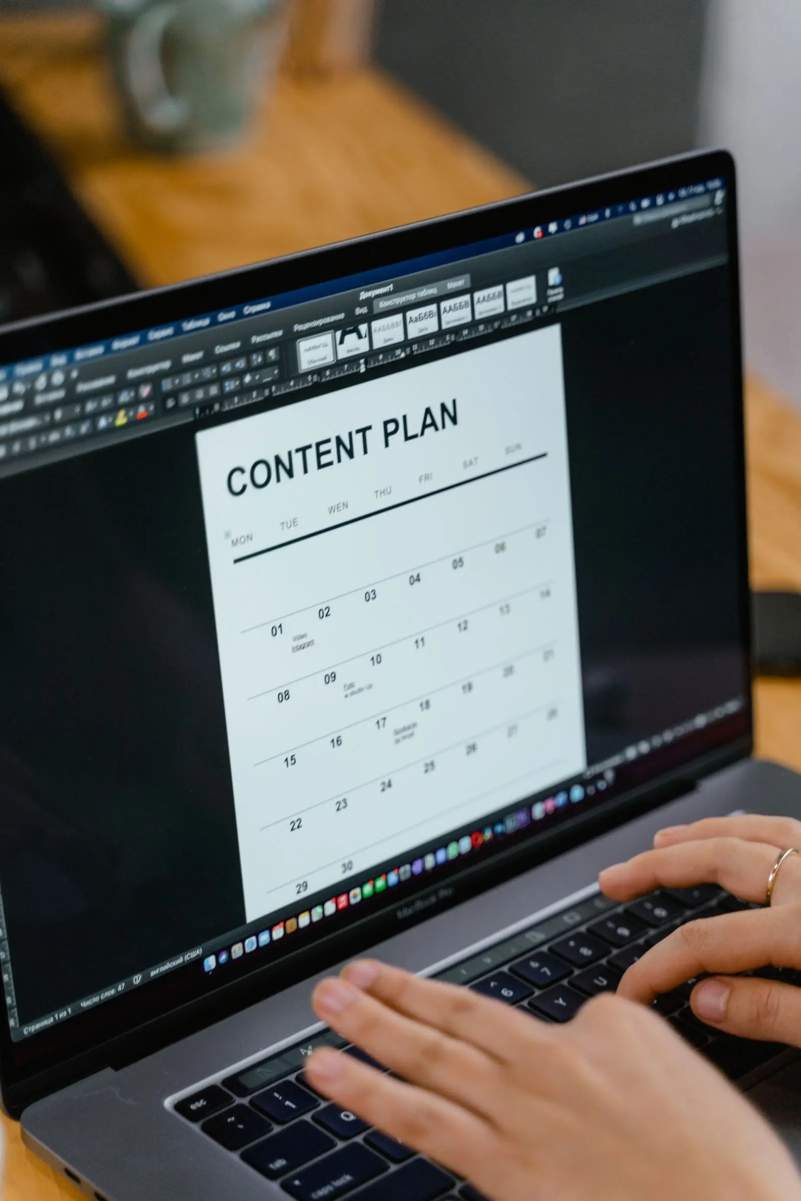 Manos escribiendo contenido en un portátil